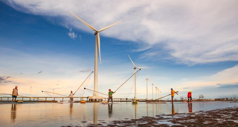 Wind turbines and men fishing